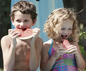 kids eat watermelon in the summer