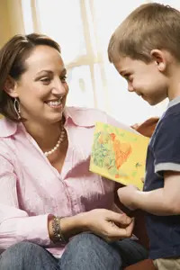 little boy giving mom a Mother's Day card