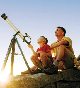 national astronomy day; father and son looking through a telescope
