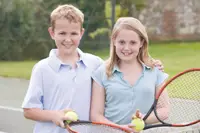 free tennis lessons in Brooklyn; girl and boy playing tennis