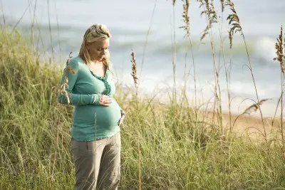Pregnant woman by beach 