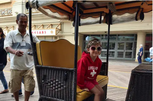 The author's daughter rides the Rolling Chairs on Atlantic City's boardwalk.