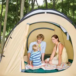 family camping in the woods; in a tent