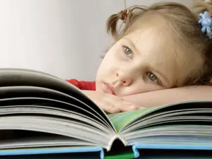 Sad little girl with book 
