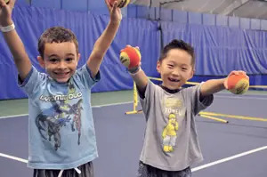 Two little boys on tennis court