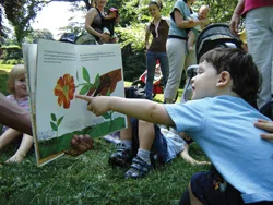 storytelling circle; child pointing at story book