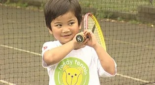 child playing tennis