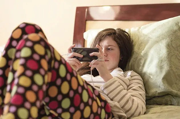 teen girl playing on phone