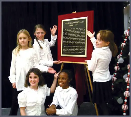 students-presenting-plaque