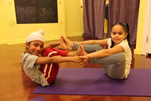 Little kids in a yoga pose