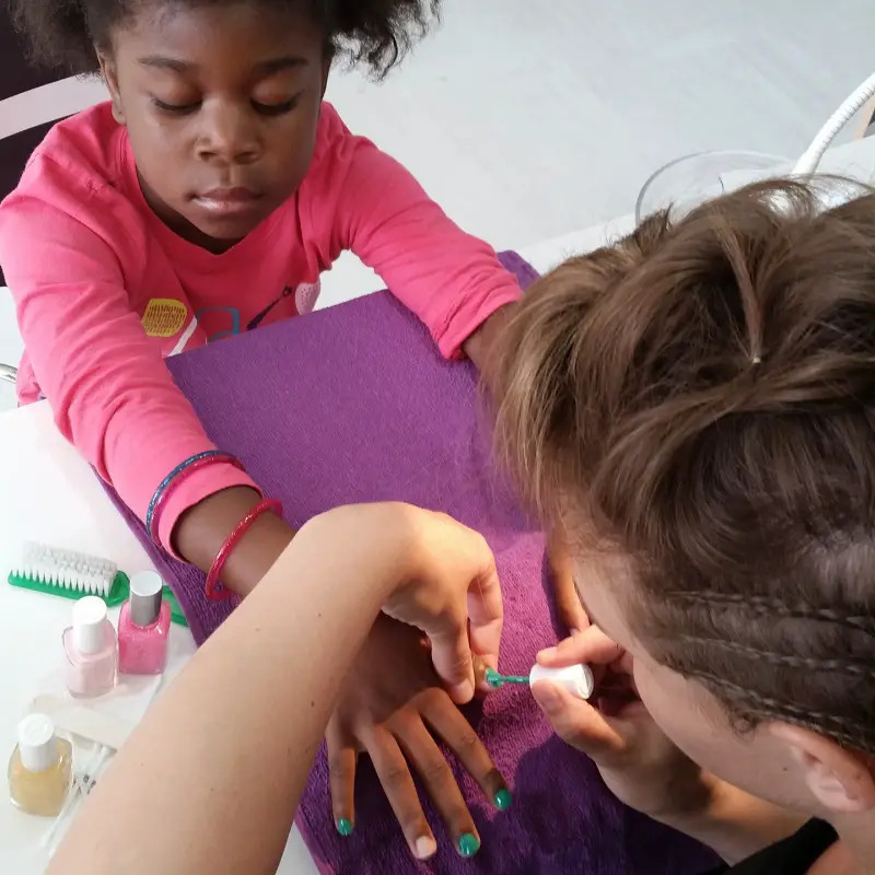 young girl getting manicure