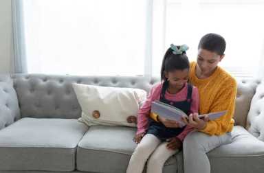 Front,View,Of,African,American,Mother,And,Daughter,Reading,A