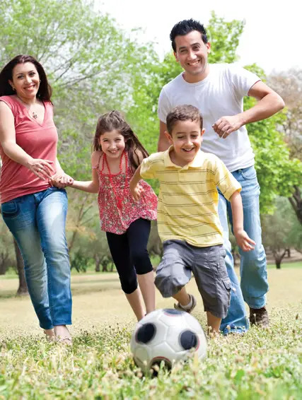 active family playing outside