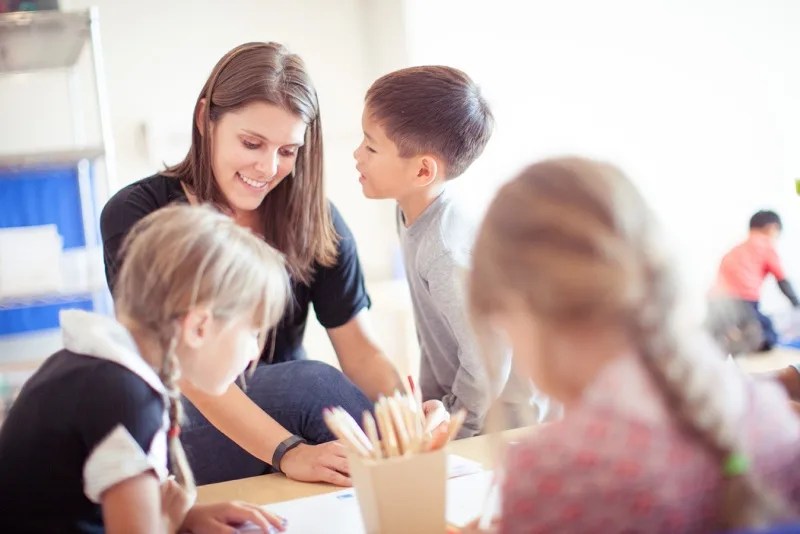 teacher working with students at AltSchool