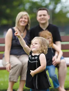 autistic child with family; young girl with special needs