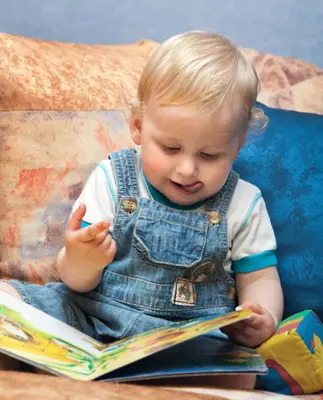 baby boy reading a book