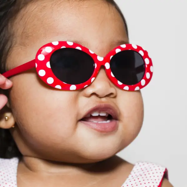 baby wearing red polka dot sunglasses