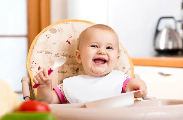 baby sitting in highchair