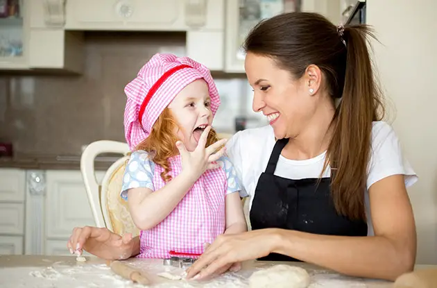 child baking with a babysitter