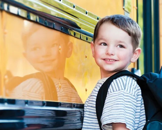 back to school, child getting on the bus