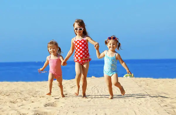 girls running on the beach