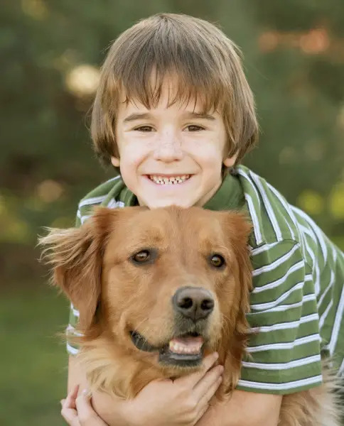 boy hugging dog