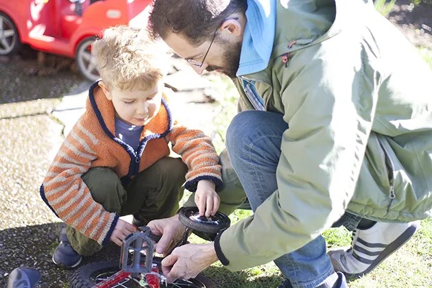 father and son working on bike