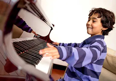 young boy playing piano