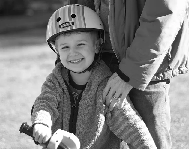 boy smiling on bike