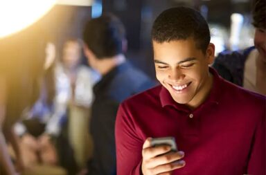 boy-smiling-while-texting-copy