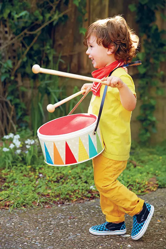 boy playing toy drum