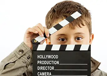 boy with movie clapper board