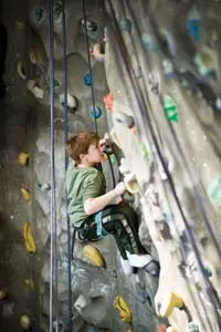 boy climbing on a climbing wall