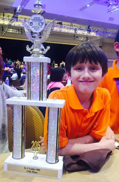 Dylan Eisenburg of Success Academy Williamsburg with chess trophy