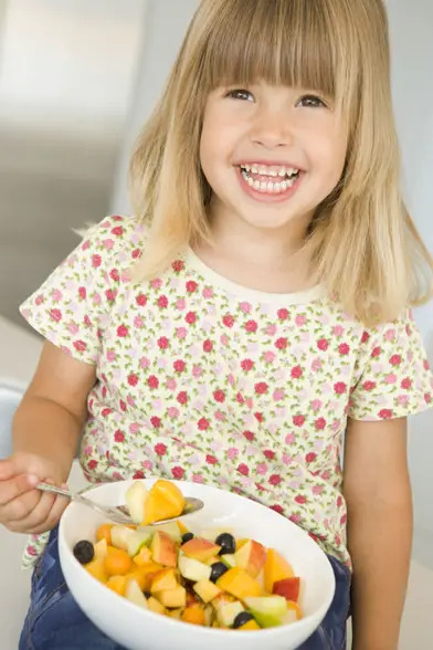 child eating fruit