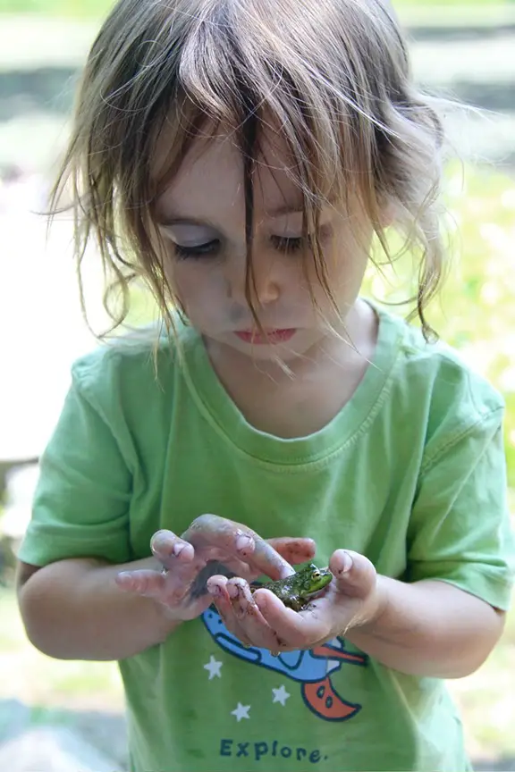 child holding frog