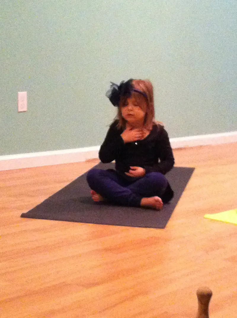 child in yoga pose