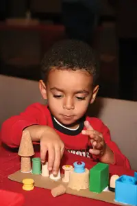 child making festive craft; Kwanzaa celebration