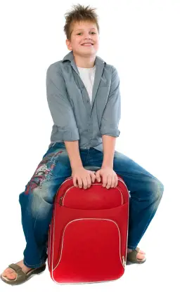boy sitting on overnight bag