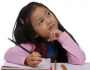 young child writing poetry; little girl writing notes, looking thoughtful