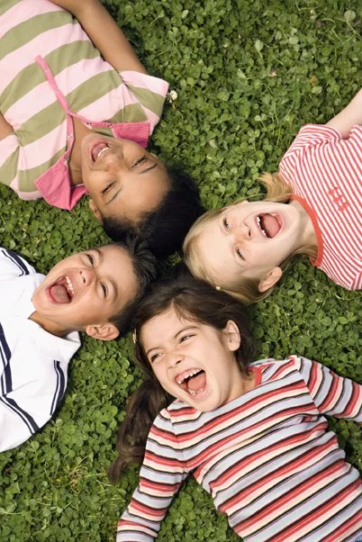 children laying on grass