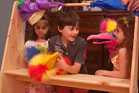 children playing puppet theater