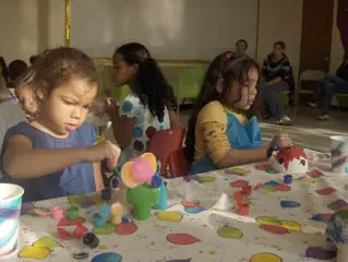 children painting figurines at chilibeans