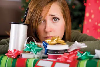 stressed out mom wrapping Christmas presents; overwhelmed by holidays