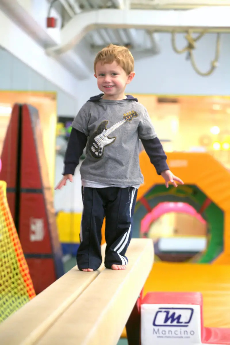 toddler boy on a balance beam