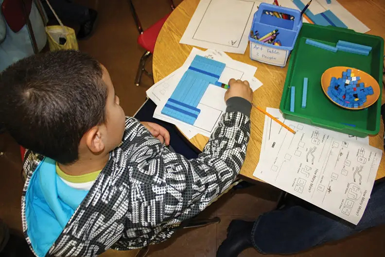 child using counting blocks