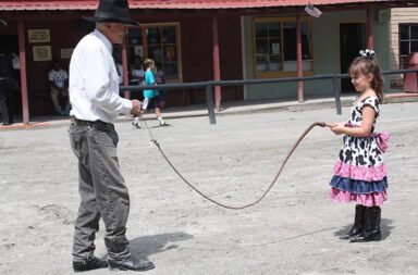 cowgirl-holds-bullwhip-with-cowboy