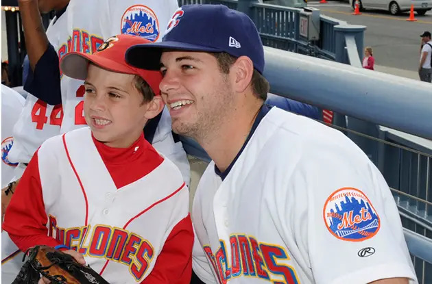 Cyclones baseball player with boy