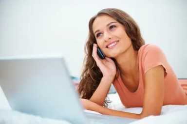 distractedwomanusinglaptoponcellphone