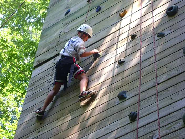 child climbing rock wall